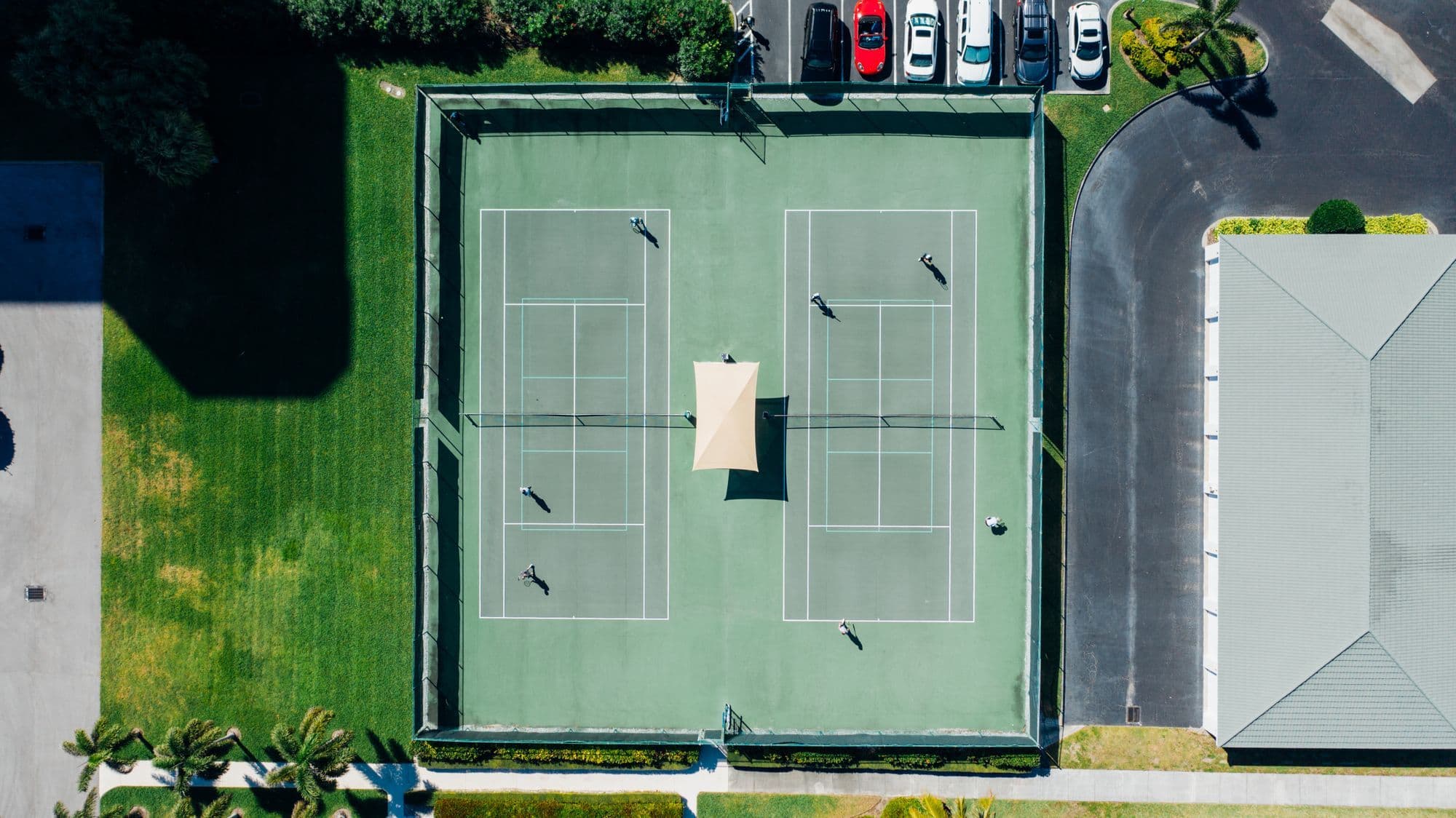Aerial view of a private tennis court beside villas