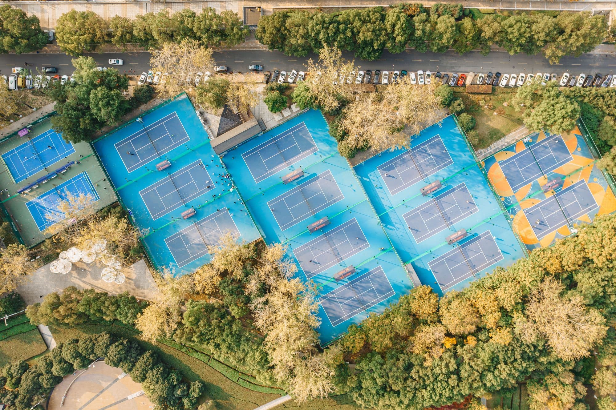 Aerial view of community tennis courts surrounded by trees