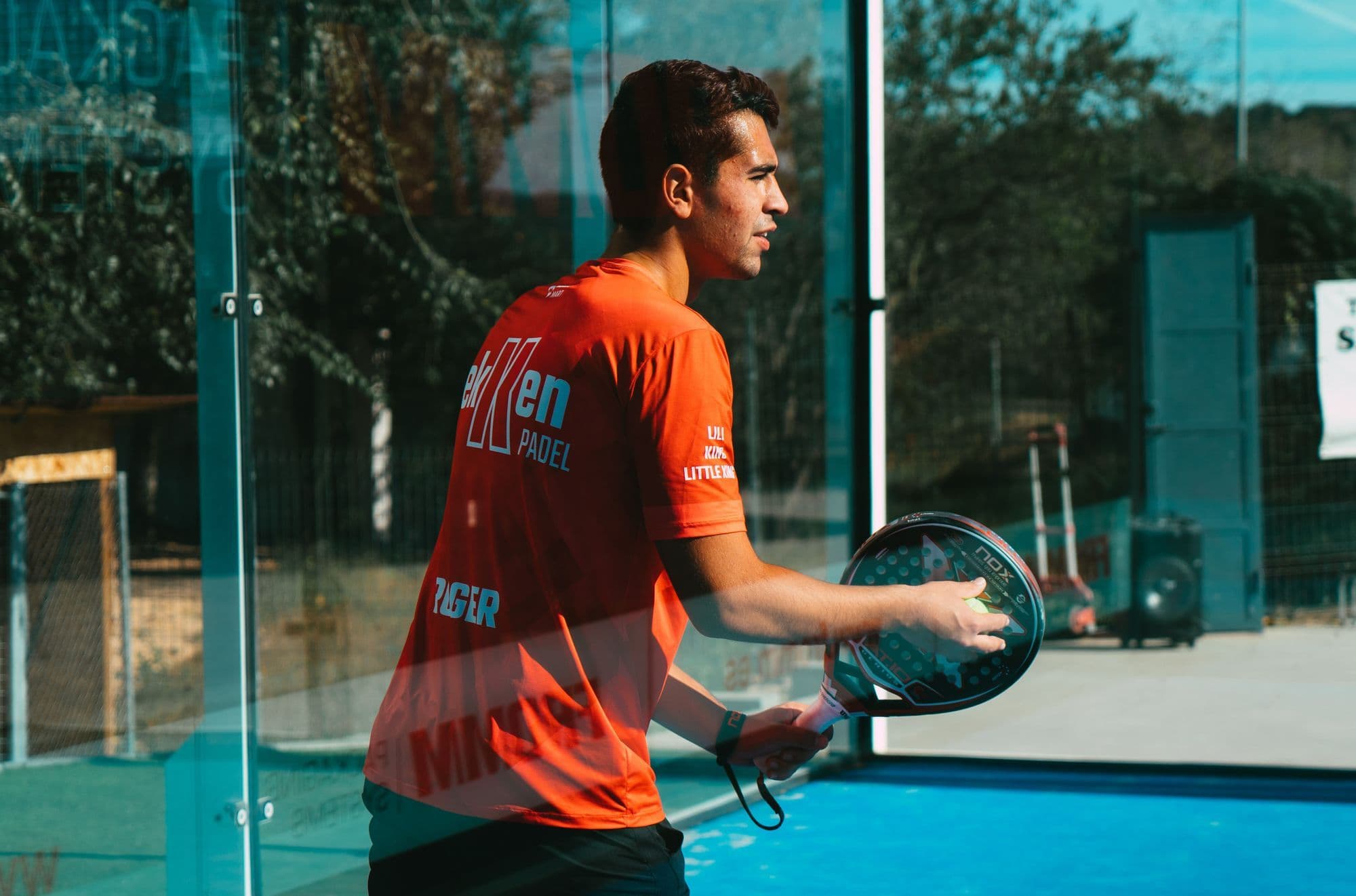 A padel player preparing a forehand