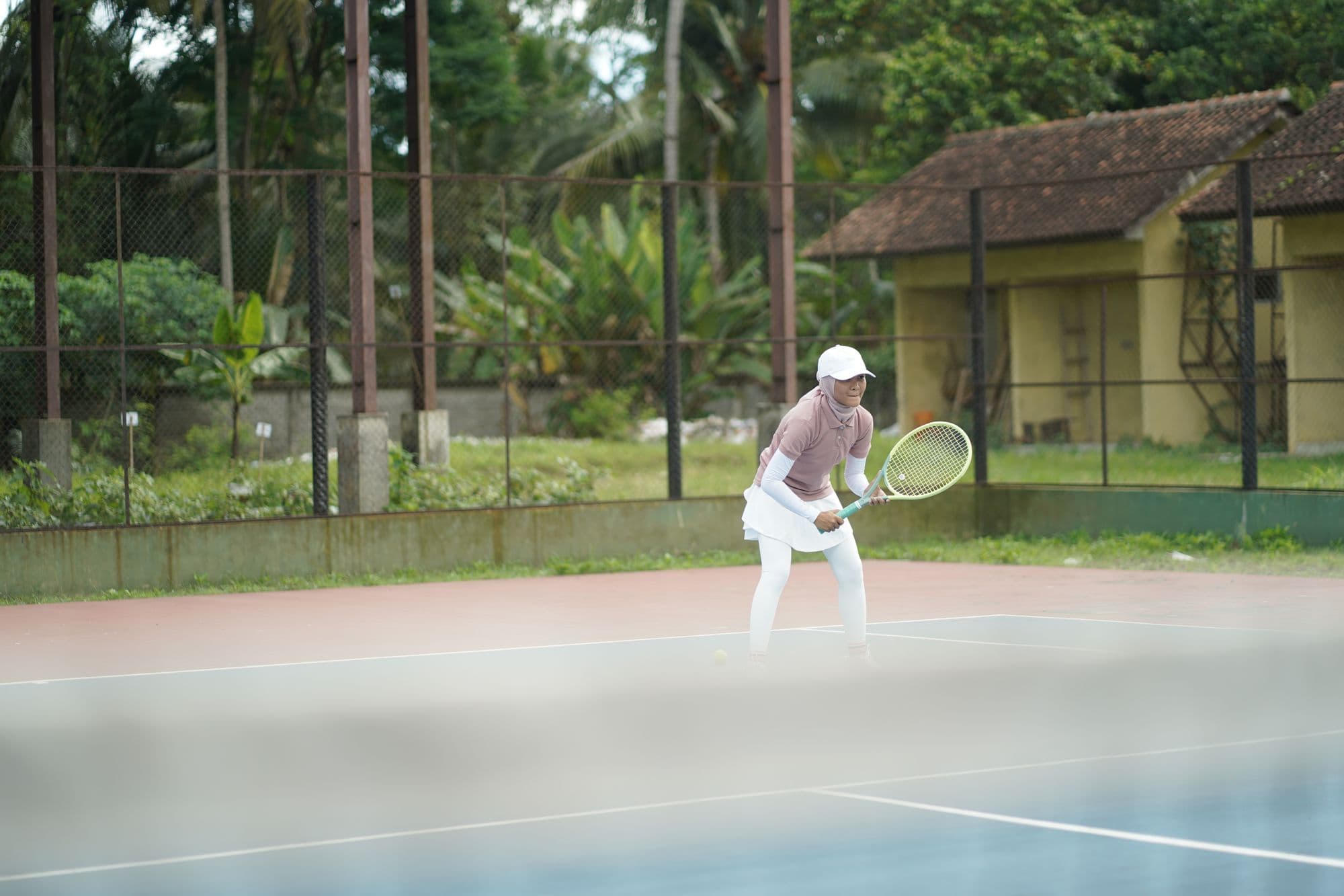 A beginner hitting forehands during a coached session