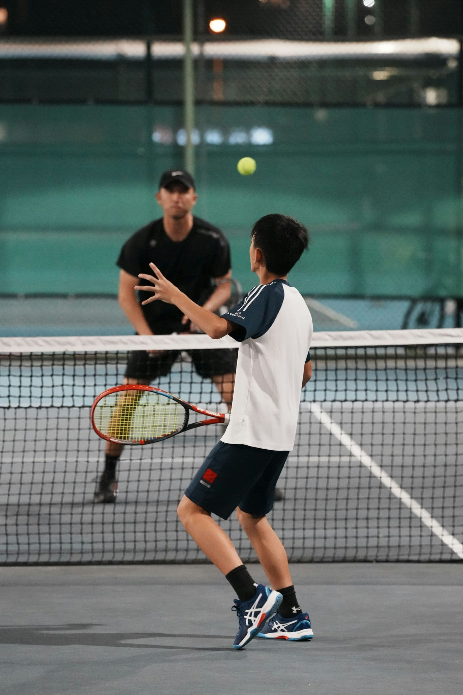 Two players meeting at the net after a match