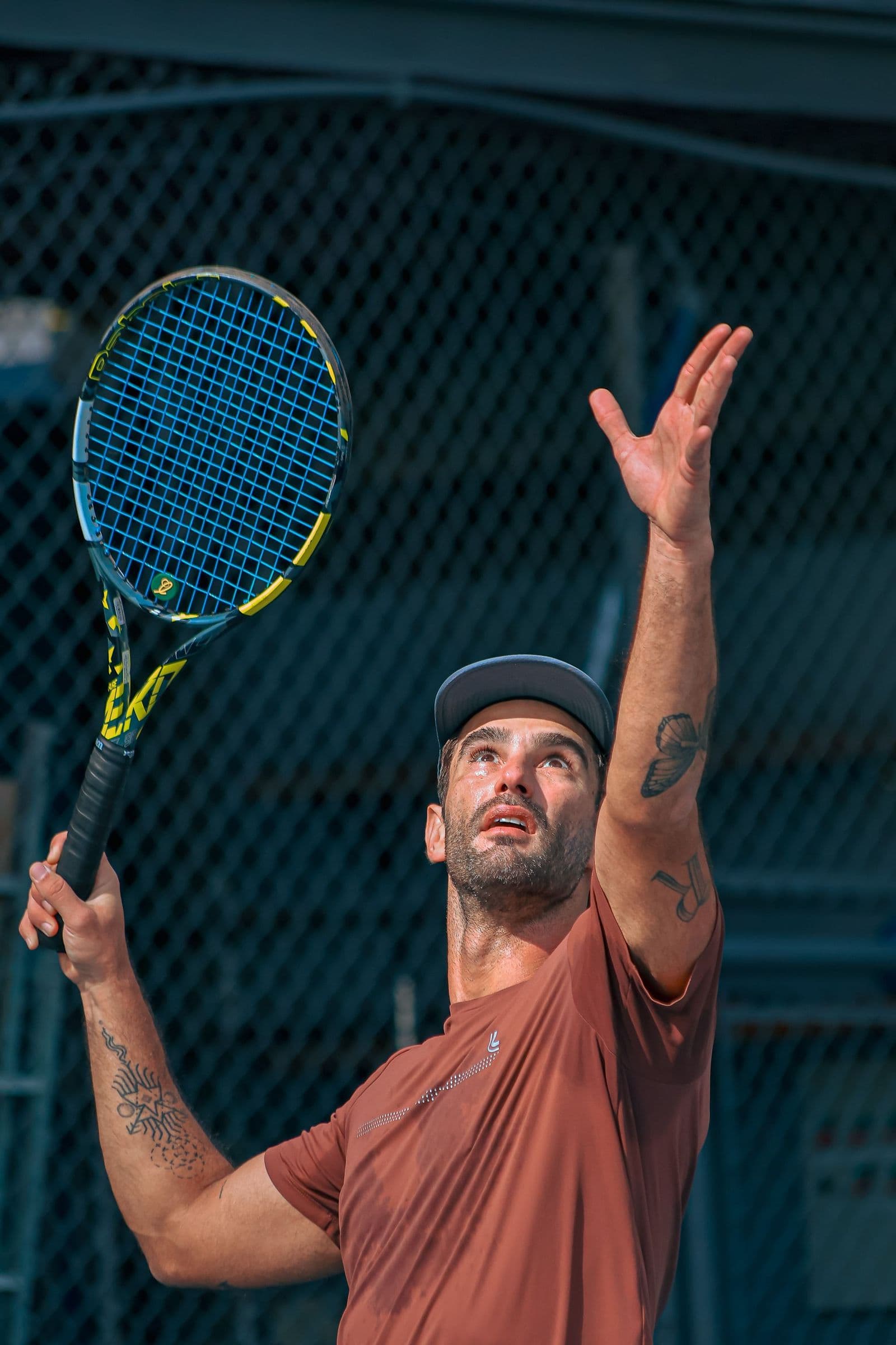 A player tossing the ball for a serve