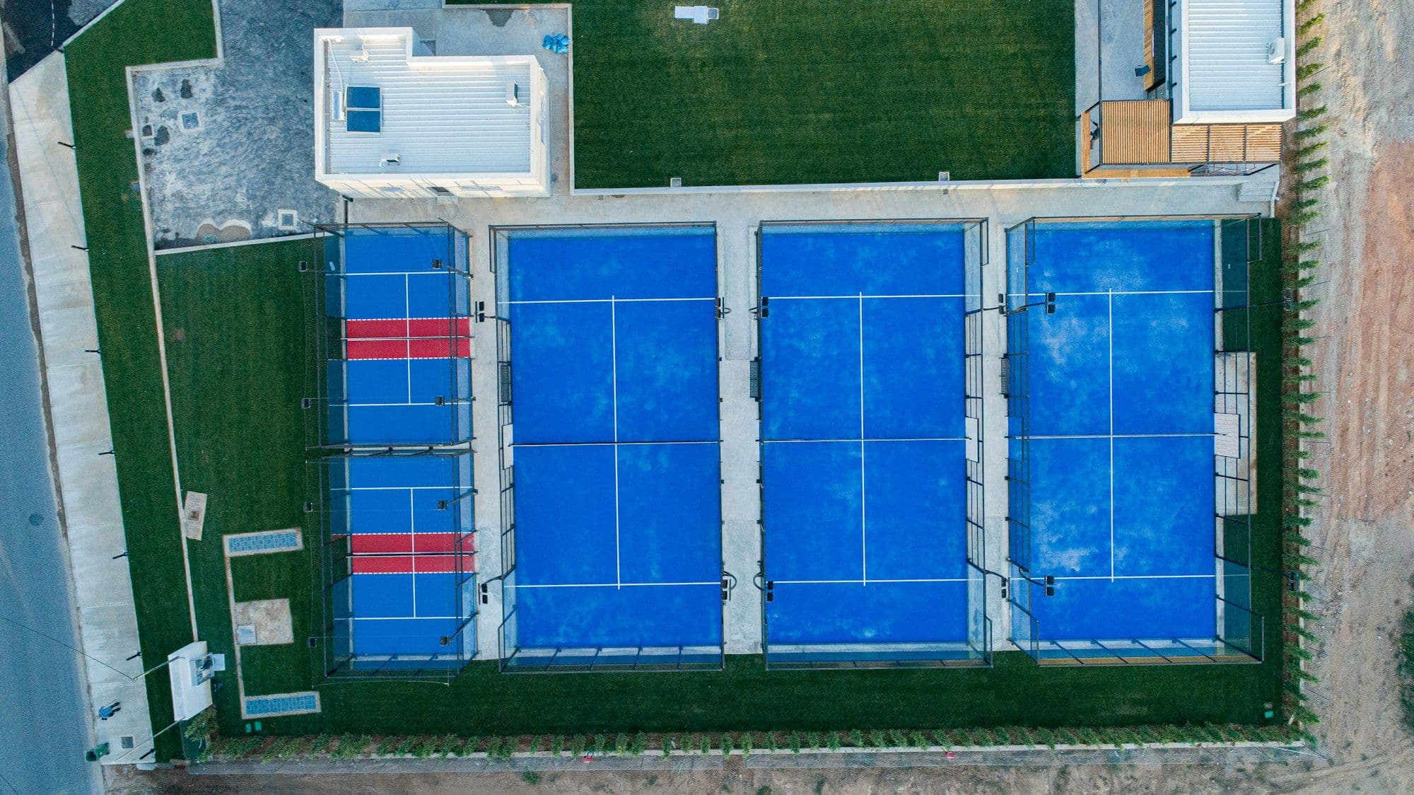 Top-down view of a row of padel courts in daylight