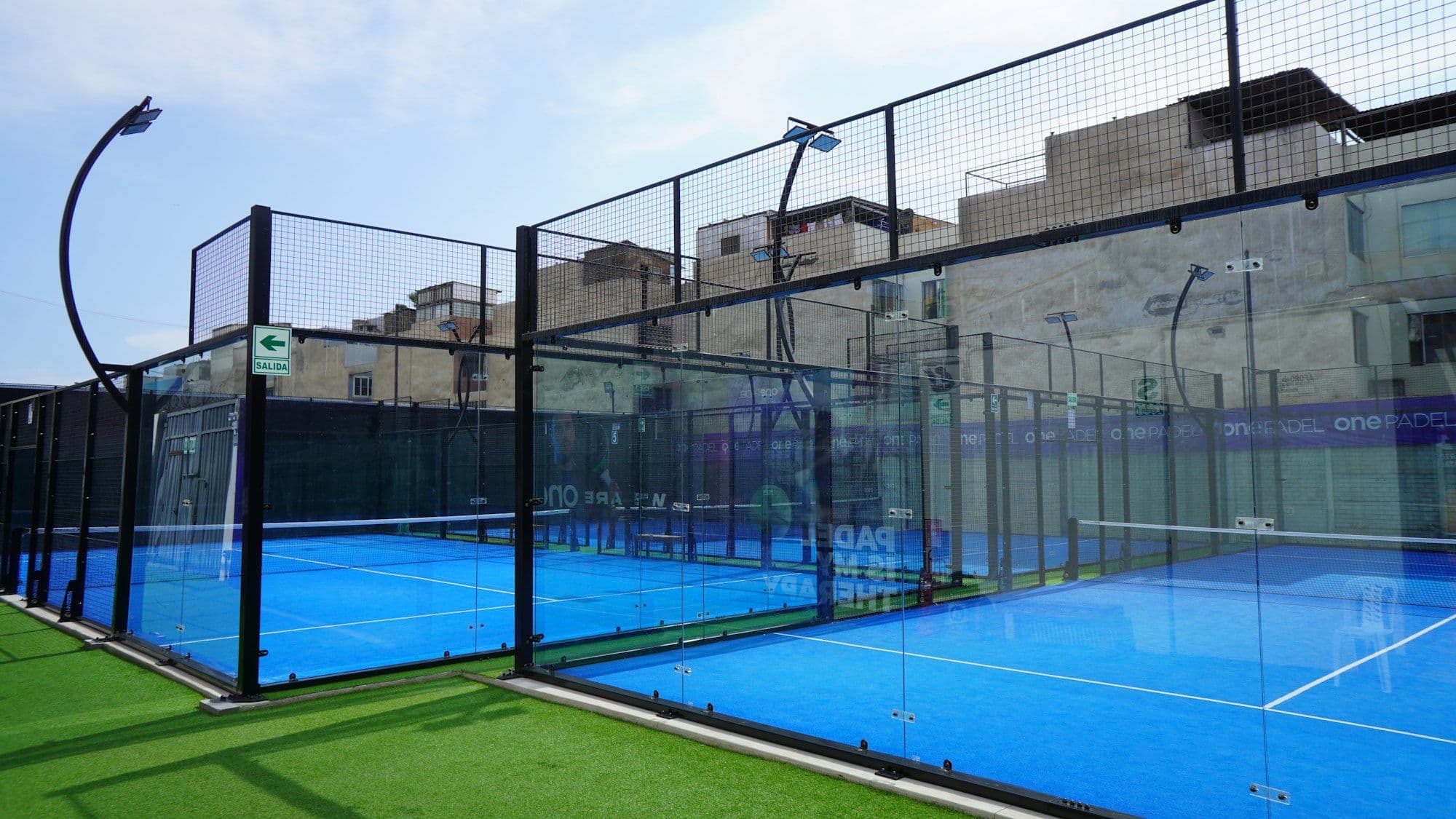 Outdoor padel courts between city buildings